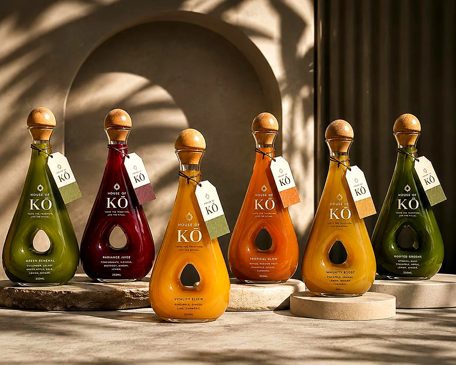 The full House of KŌ cold-pressed juice collection in signature teardrop bottles with wooden stoppers and gift tubes